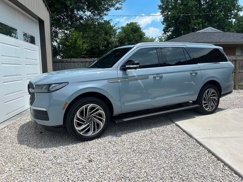 Light blue full-size SUV with tinted windows