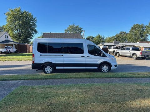 White high-roof passenger van with tinted windows