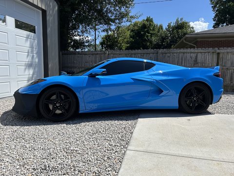 The same blue Corvette after tinting, side glass now dark