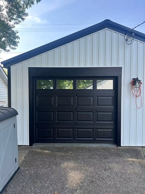 Detached garage with tinted glass panels in the door